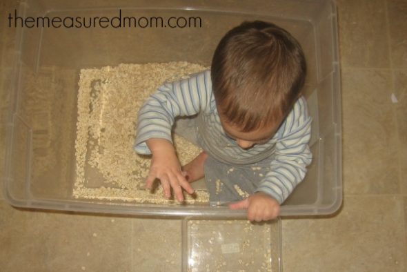 child throwing oats