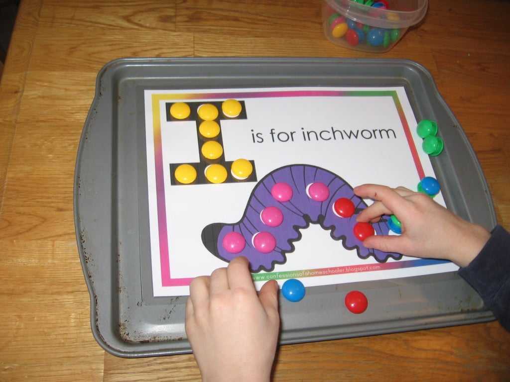 child placing magnets on worksheet