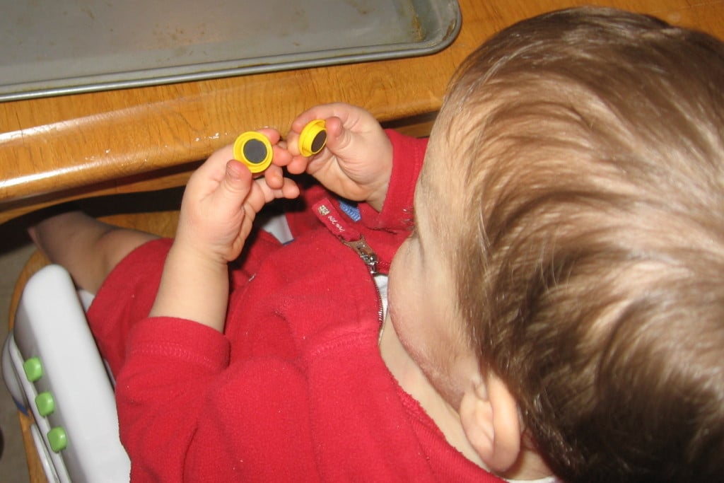 child examining magnets