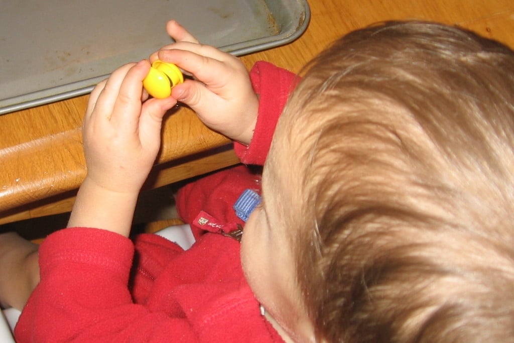 child sticking magnets together