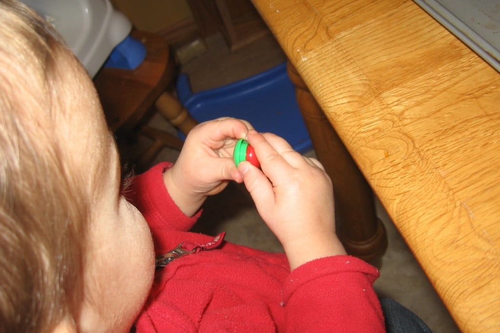 child sticking magnets together