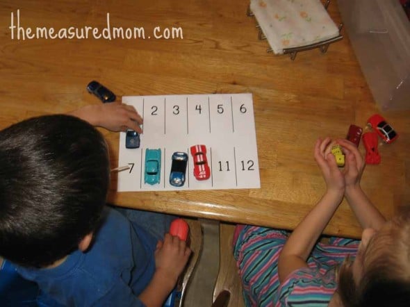 These toy car activities are great for teaching basic math skills to preschoolers. My boys loved the ramp! children rolling dice and parking cars